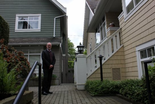 JEN ST. DENIS/METRO Michael Geller, a Vancouver architect and real estate developer, stands in front of a townhouse development he says is a good example of housing that appeals to seniors looking to downsize from large houses.